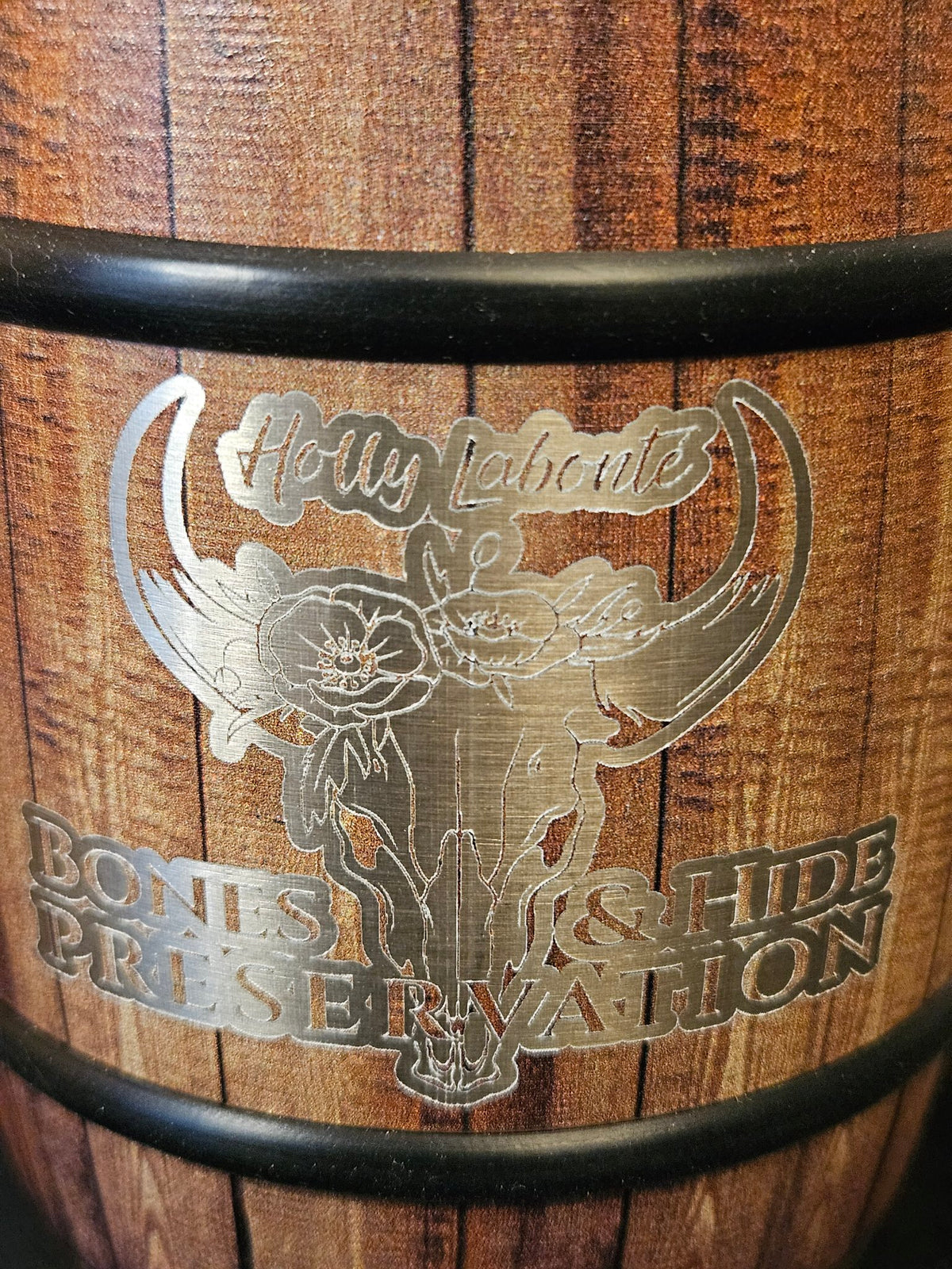 Close-up of engraved female longhorn logo on barrel mug