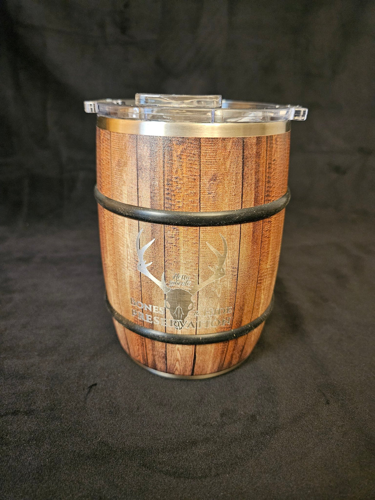 Barrel travel mug with engraved male antler logo, front