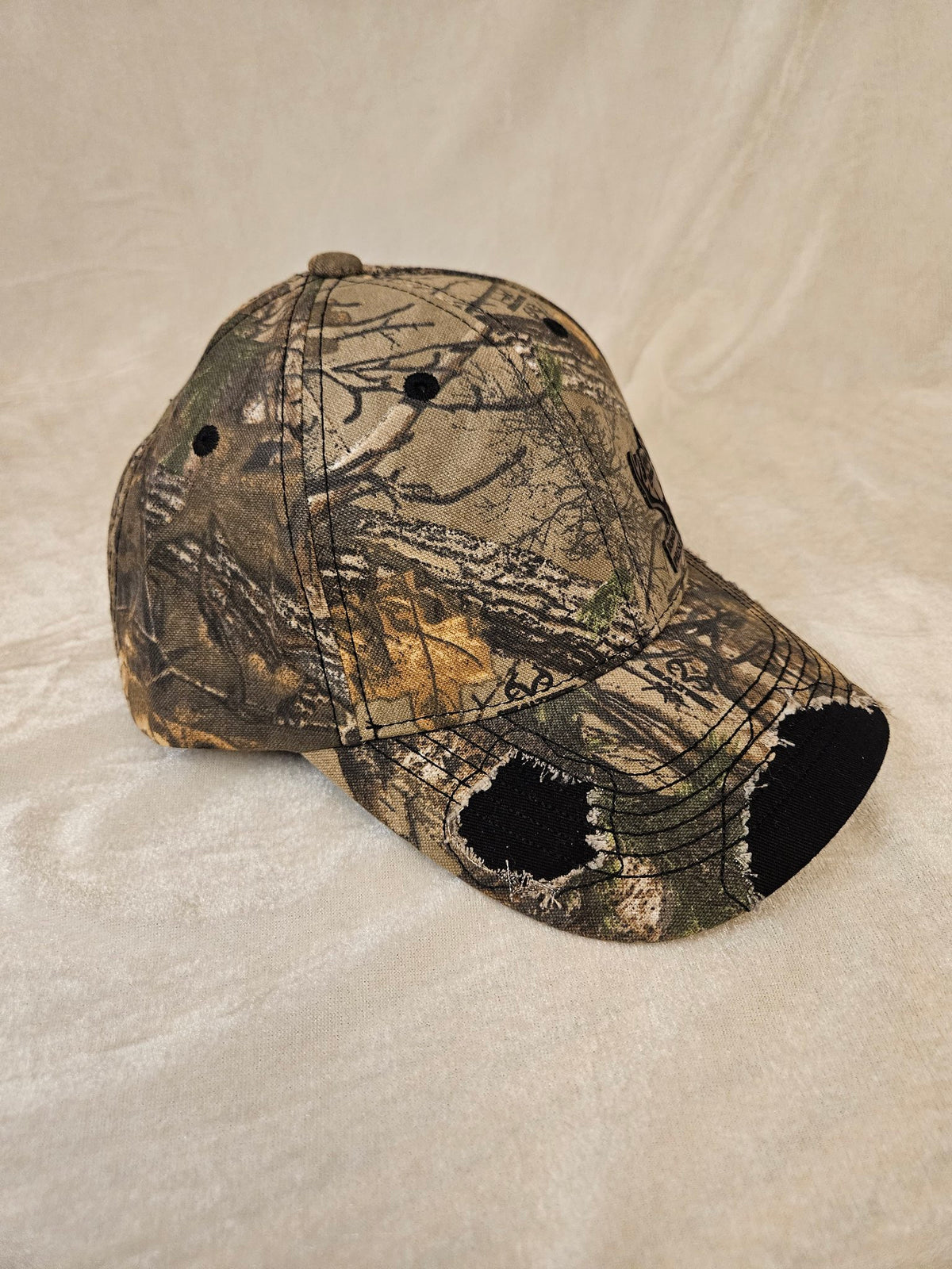 Camo hat with black distressed detailing, side