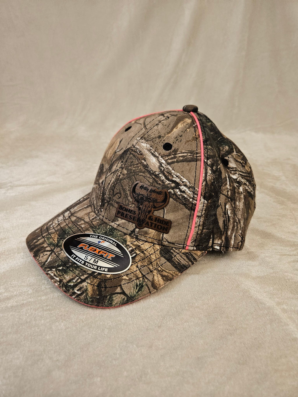 Women's camo Flexfit hat with engraved leather patch, other side