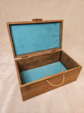 Handcrafted wooden skull box with teal velvet lining, open